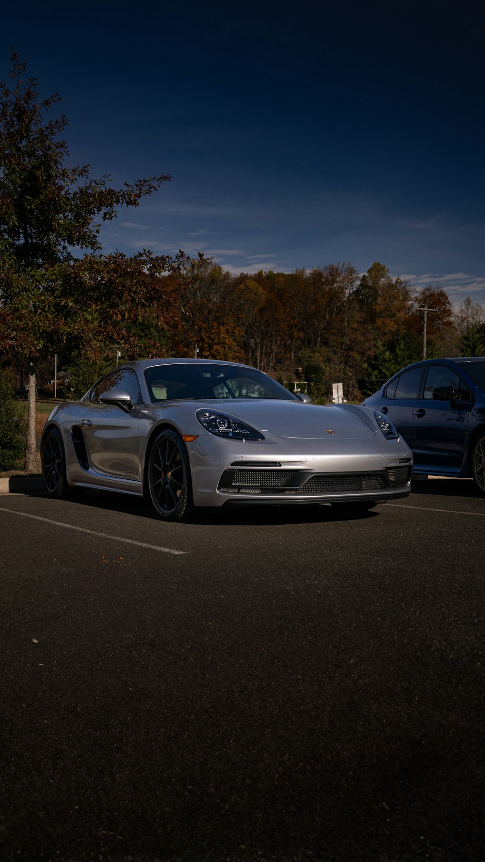 a silver sports car parked in a parking lot