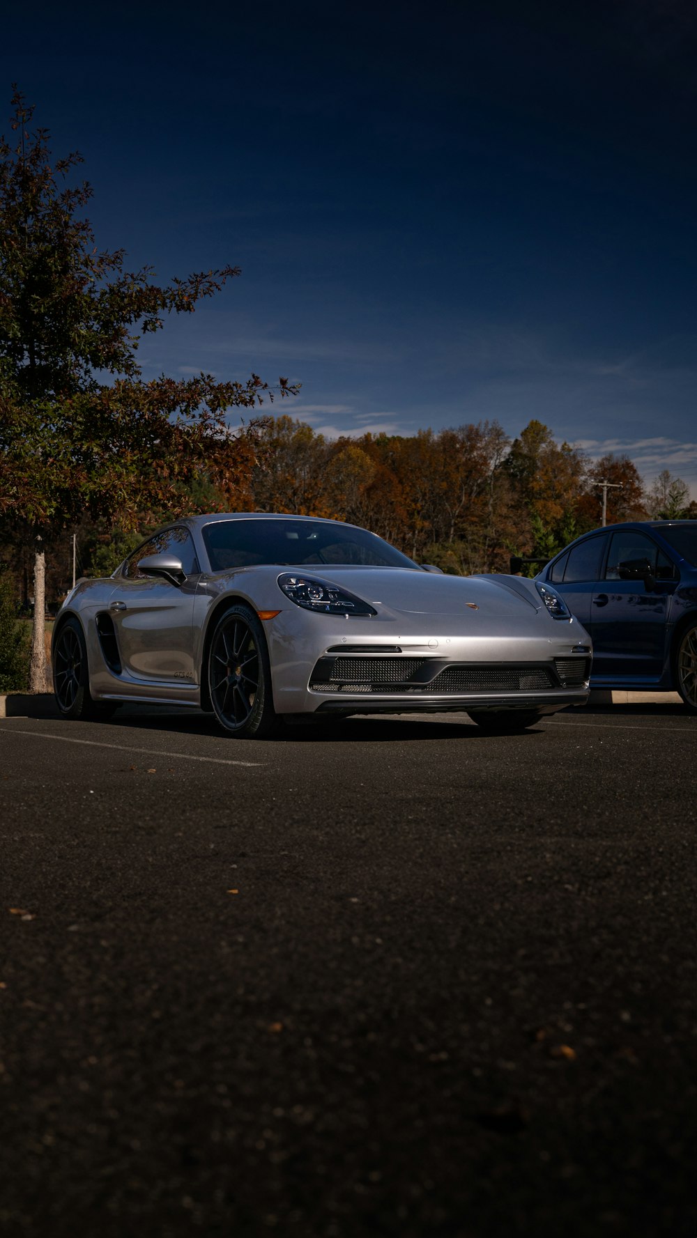 a silver sports car parked in a parking lot