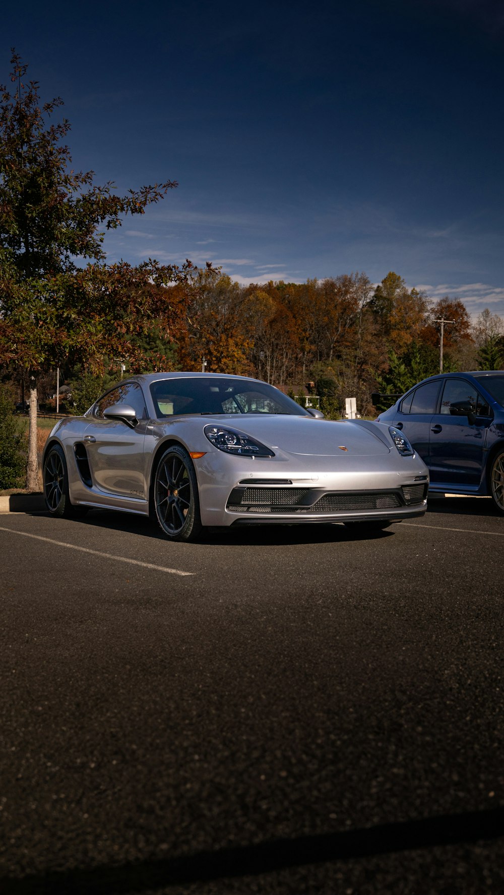 a silver sports car parked in a parking lot