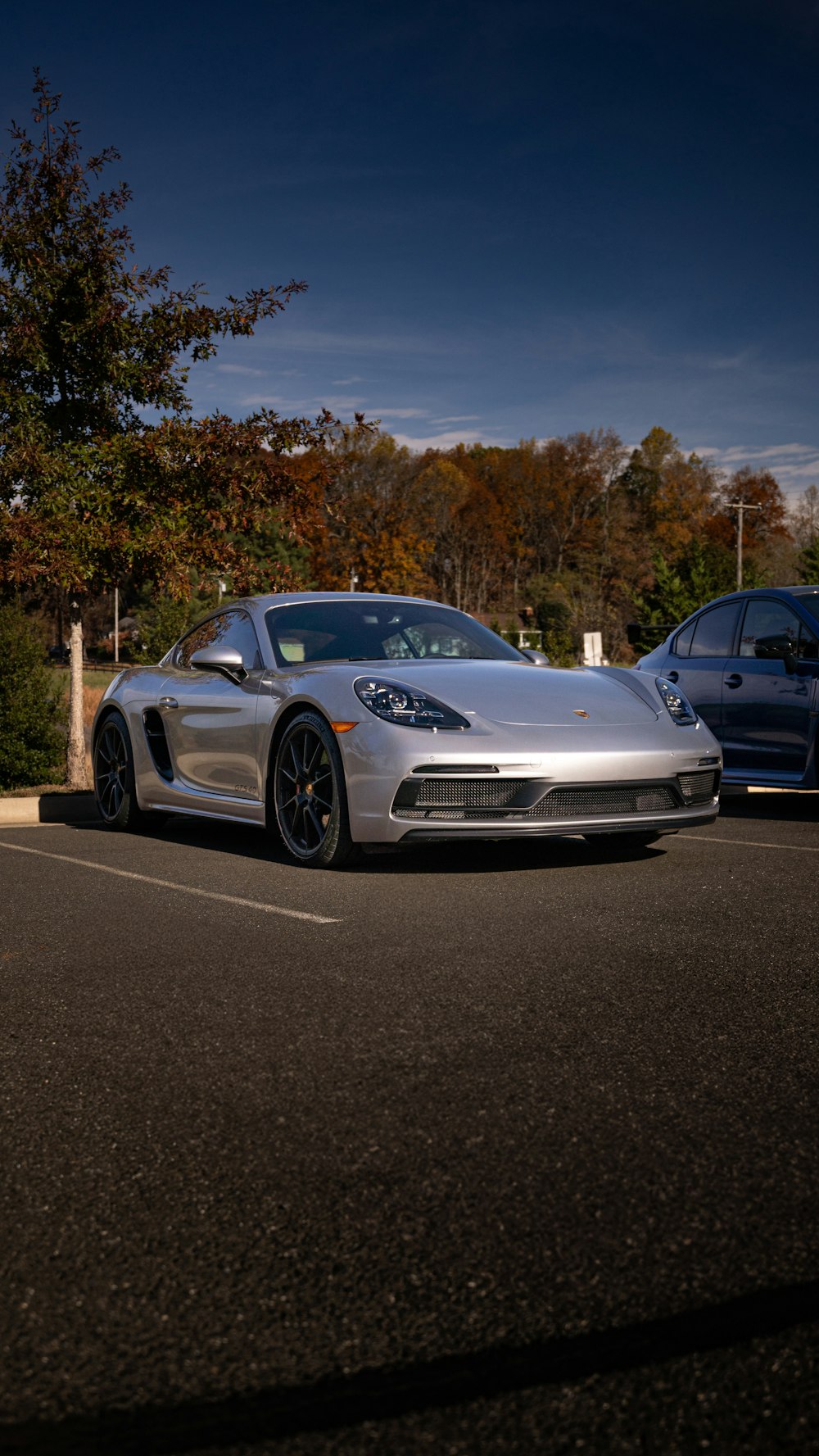 a silver sports car parked in a parking lot