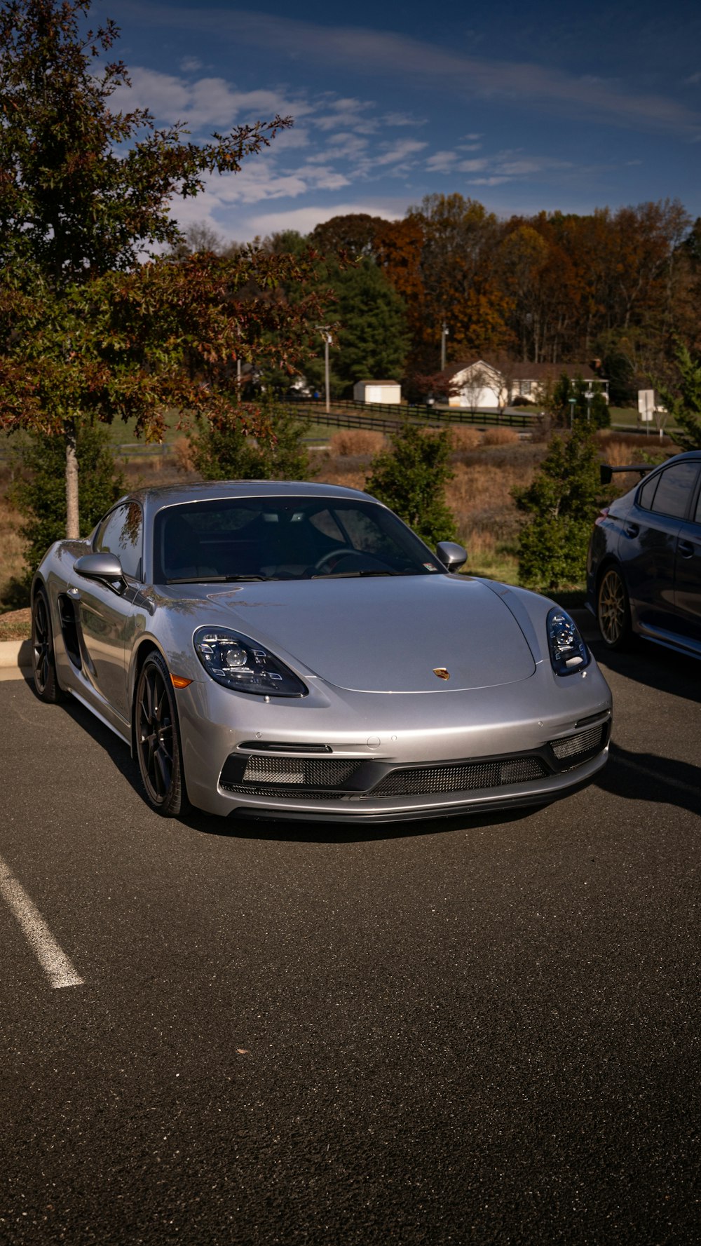 a silver sports car parked in a parking lot