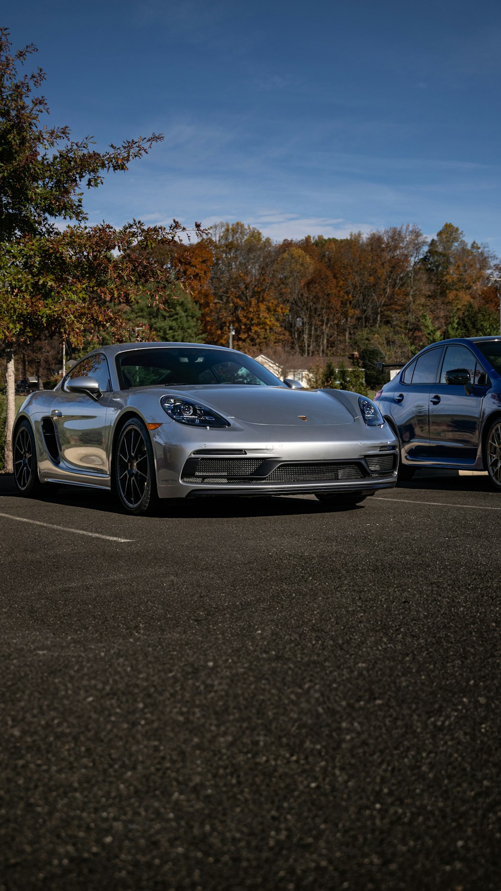 two cars parked in a parking lot next to each other