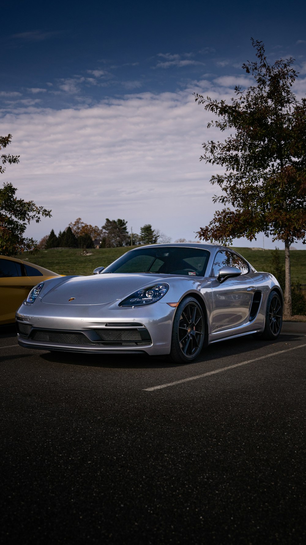 a silver sports car parked in a parking lot