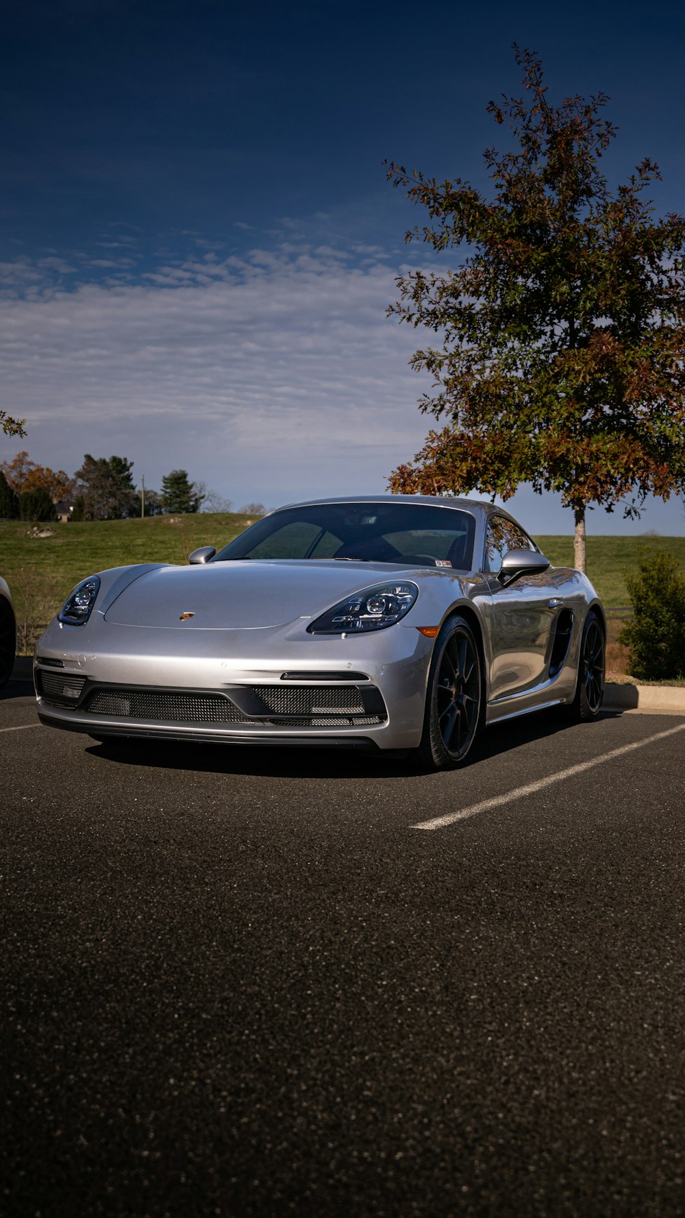 a silver sports car parked in a parking lot