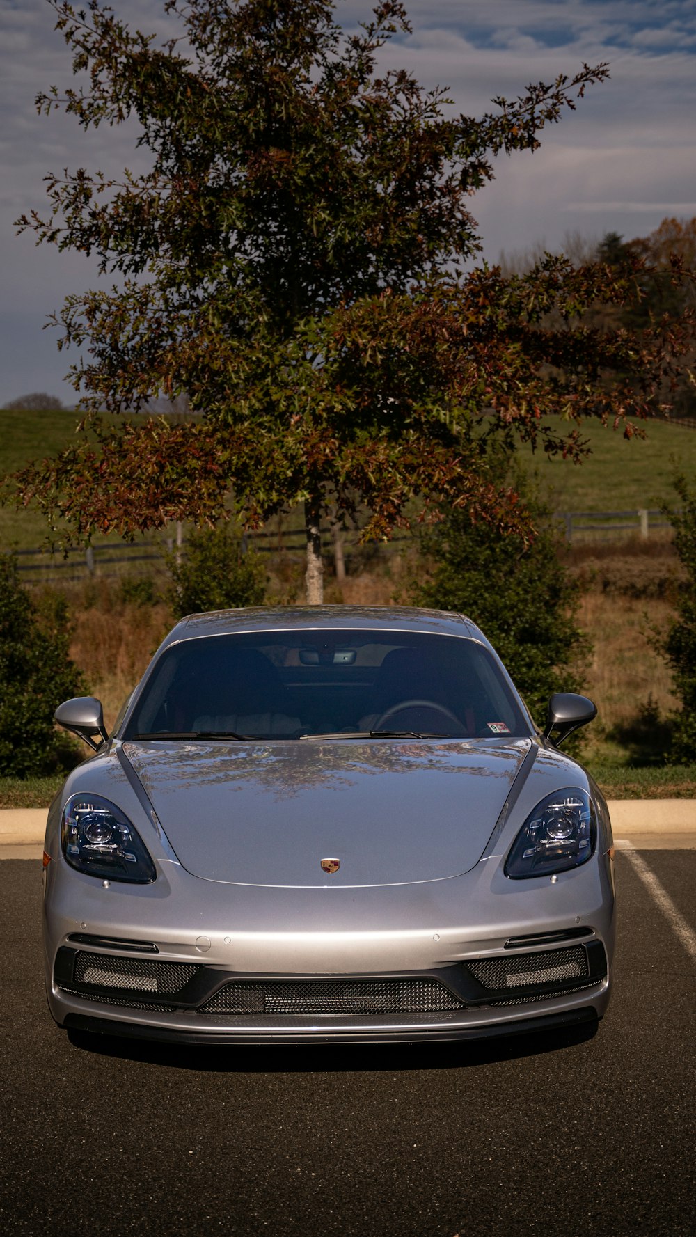 a silver sports car parked in a parking lot