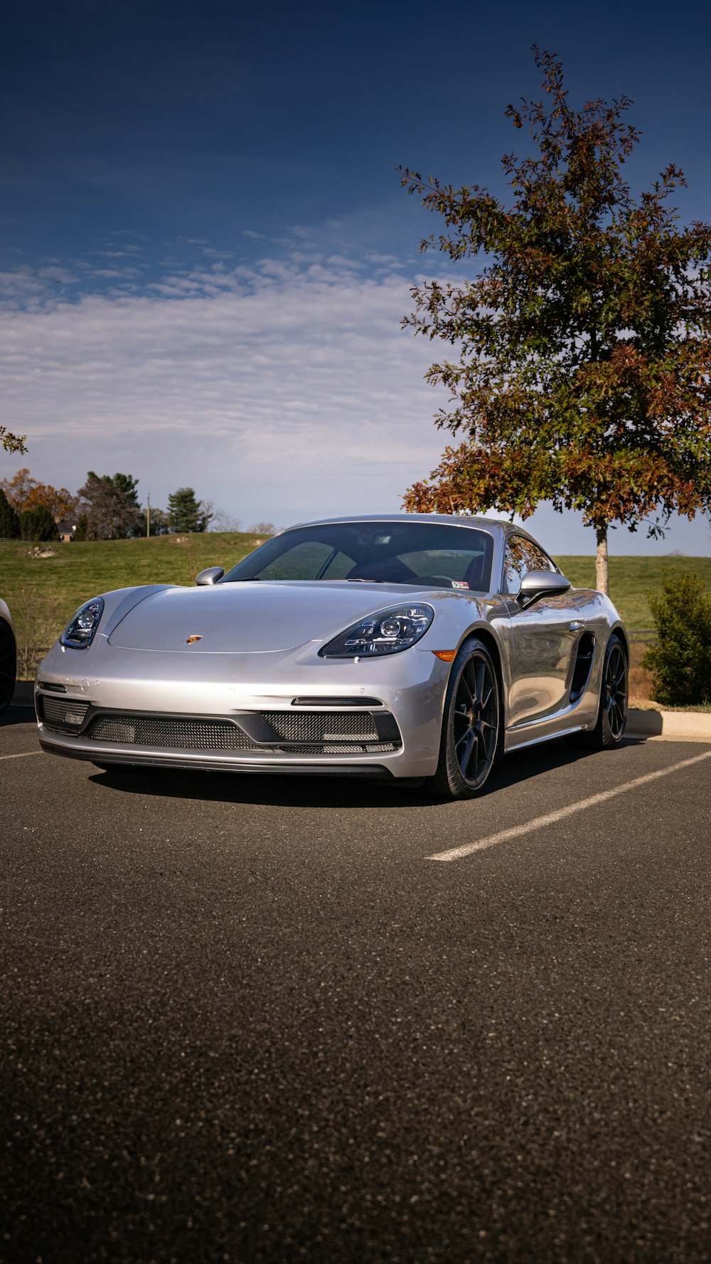 a silver sports car parked in a parking lot