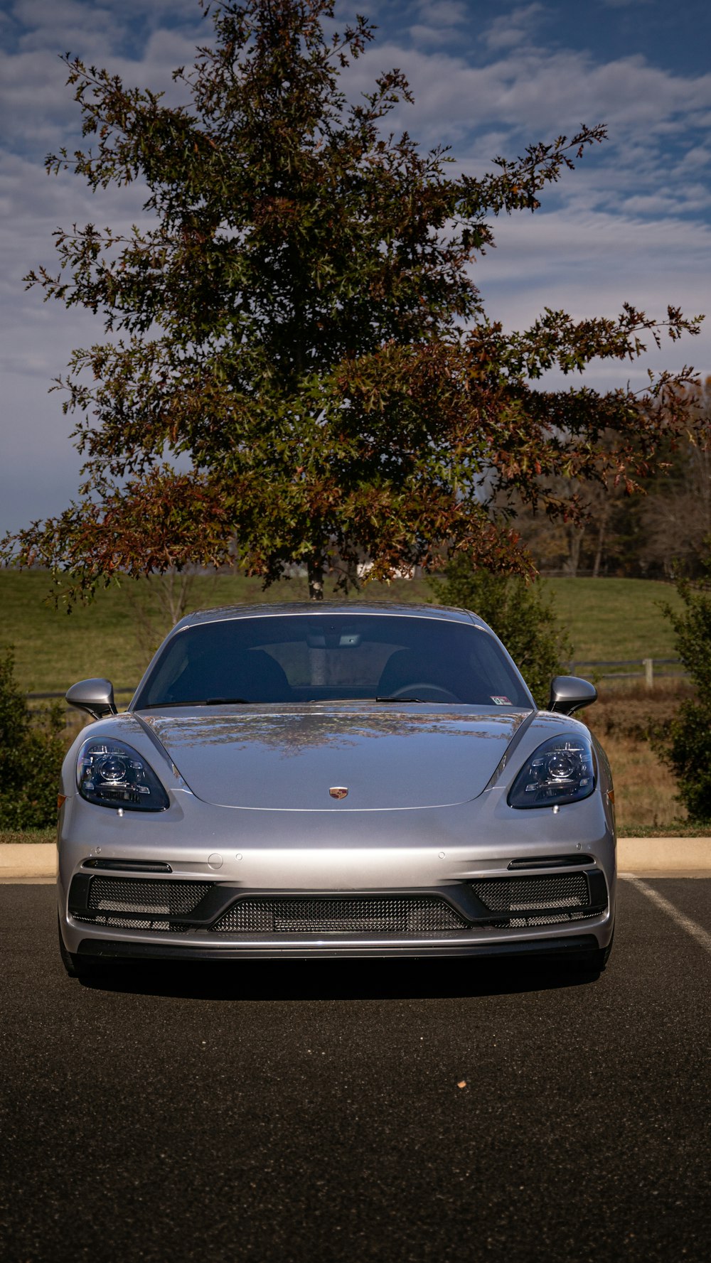 a silver sports car parked in a parking lot