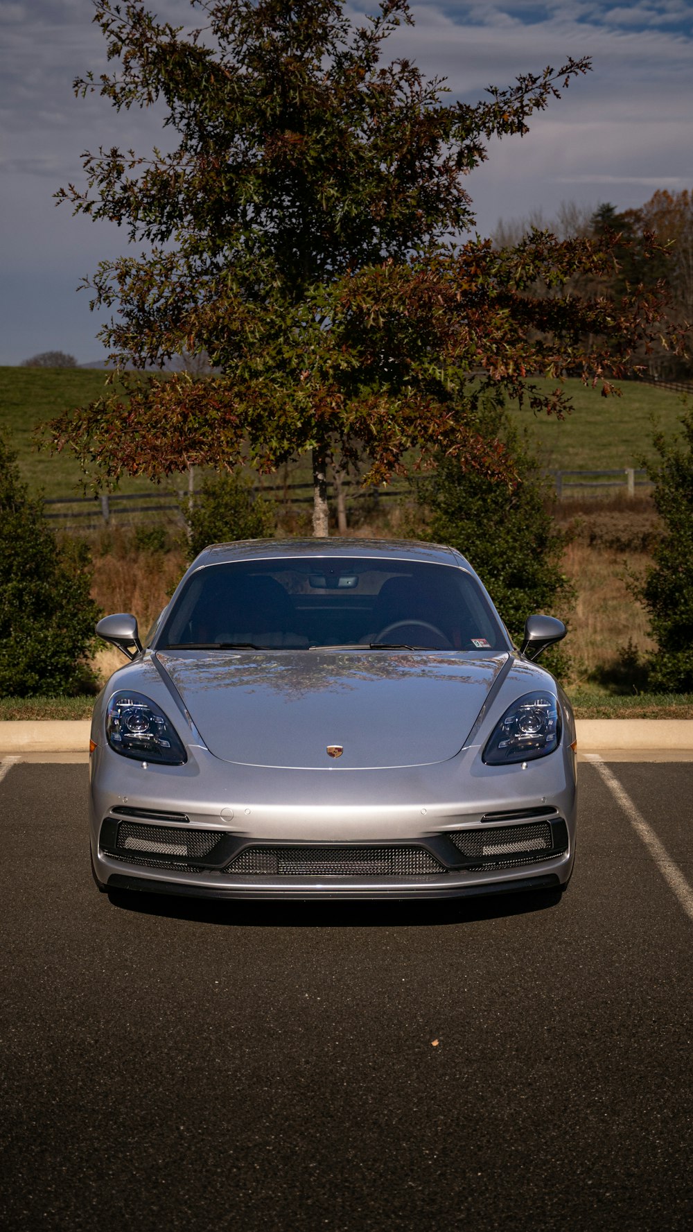 a silver sports car parked in a parking lot