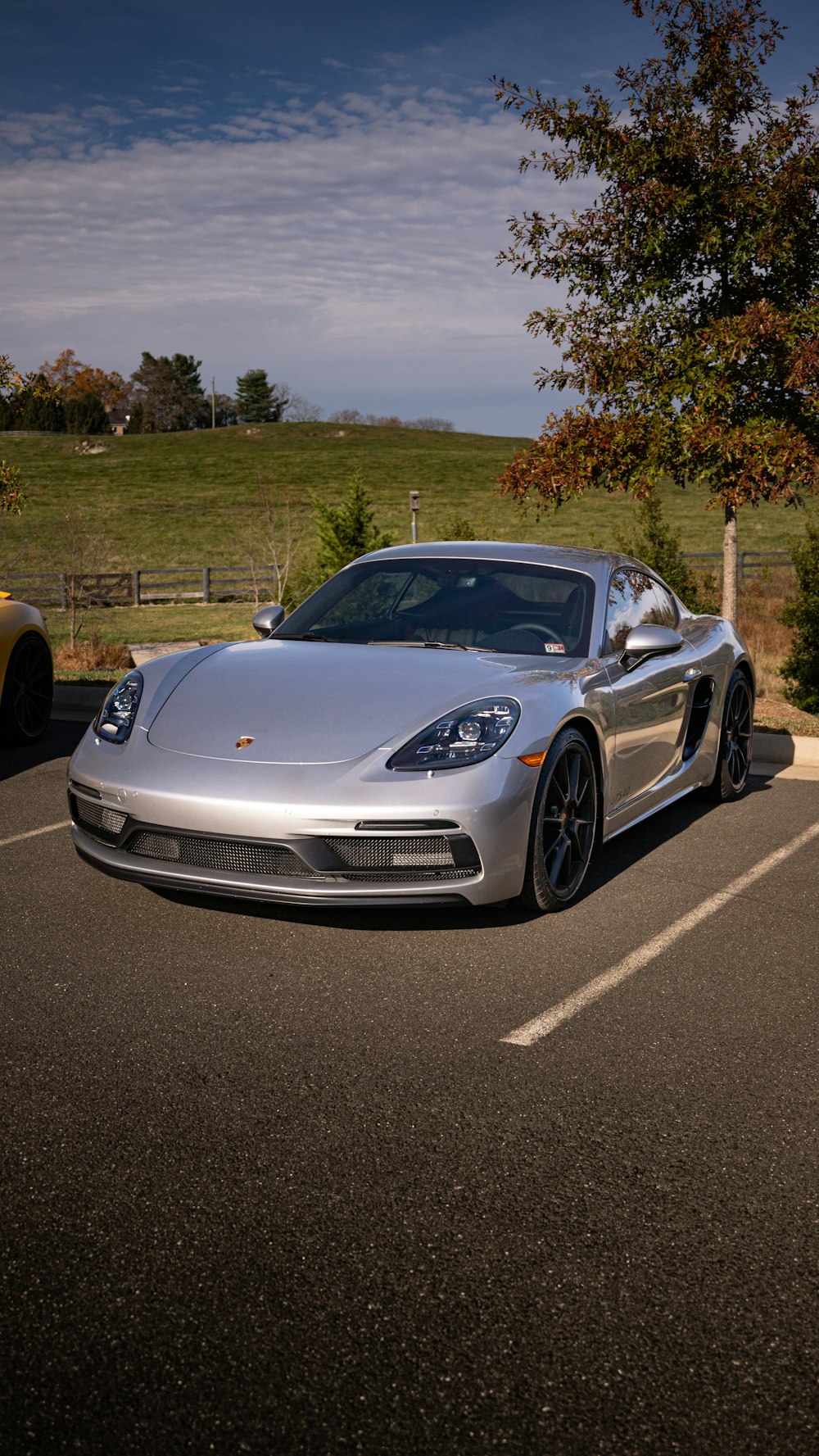 a silver sports car parked in a parking lot