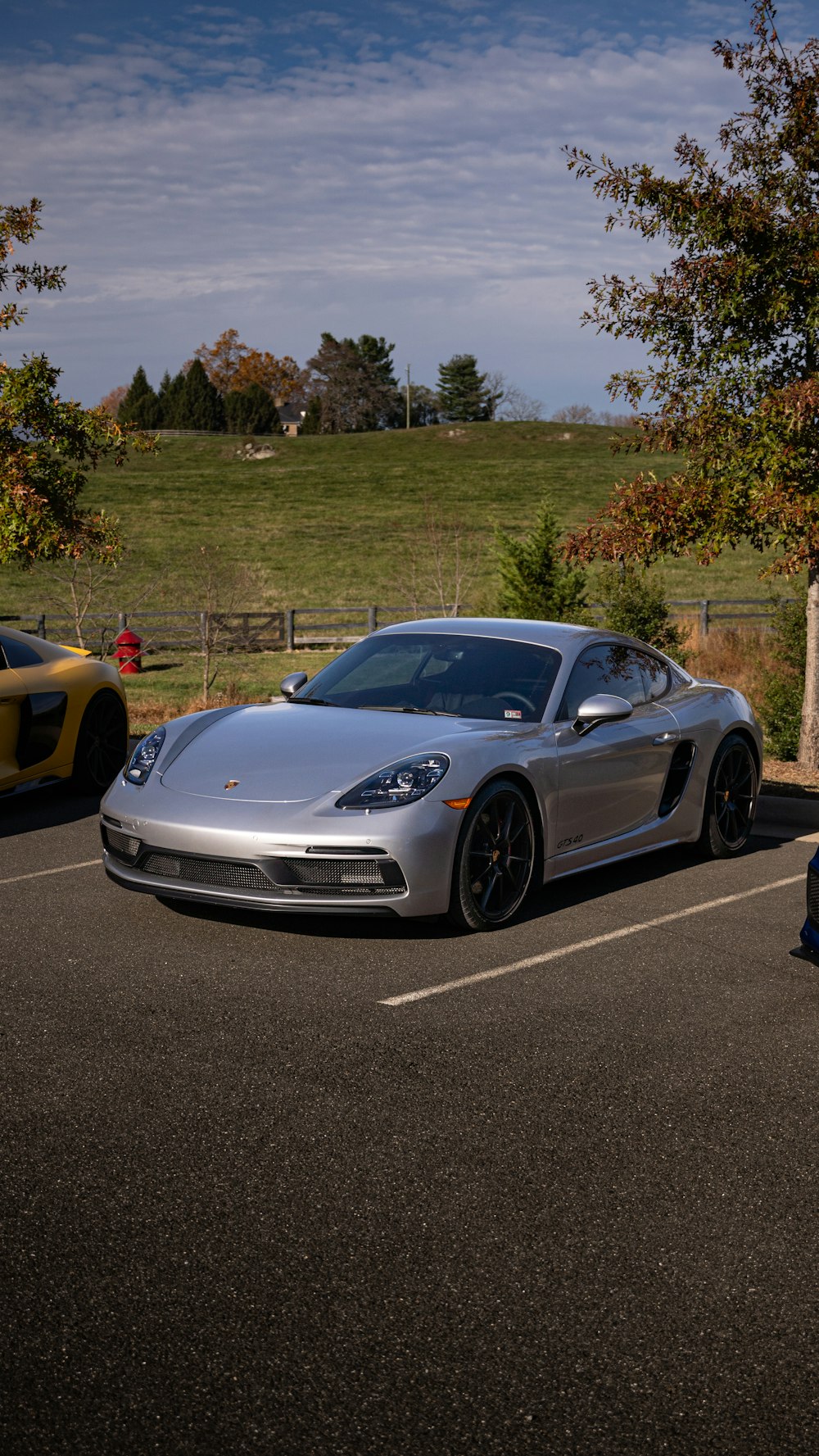 a silver sports car parked in a parking lot