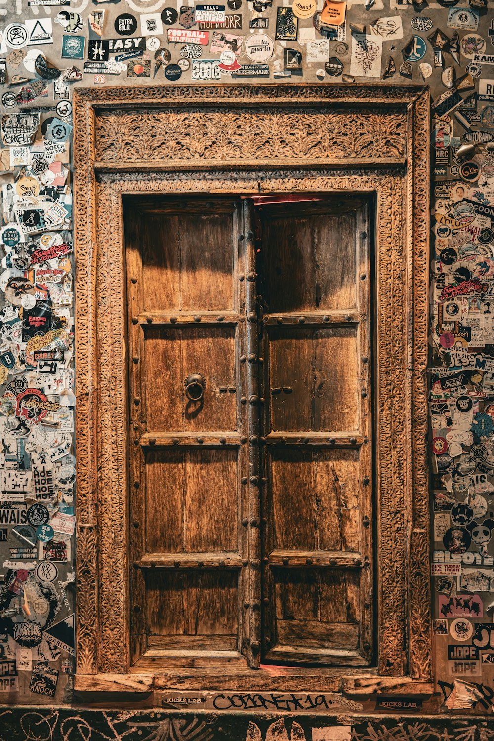 a wooden door with many stickers on it