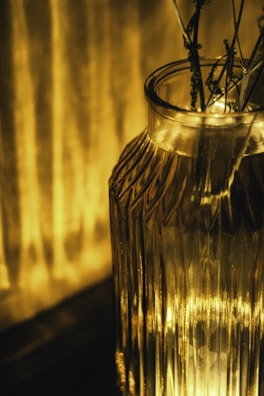 A polished wooden vase with rich grain patterns glowing under soft light.