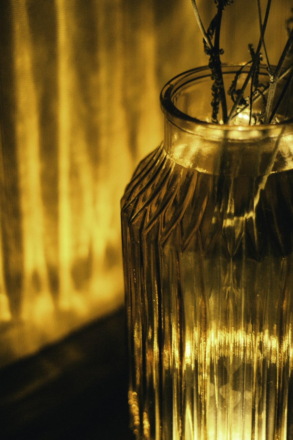 a glass vase with some flowers in it