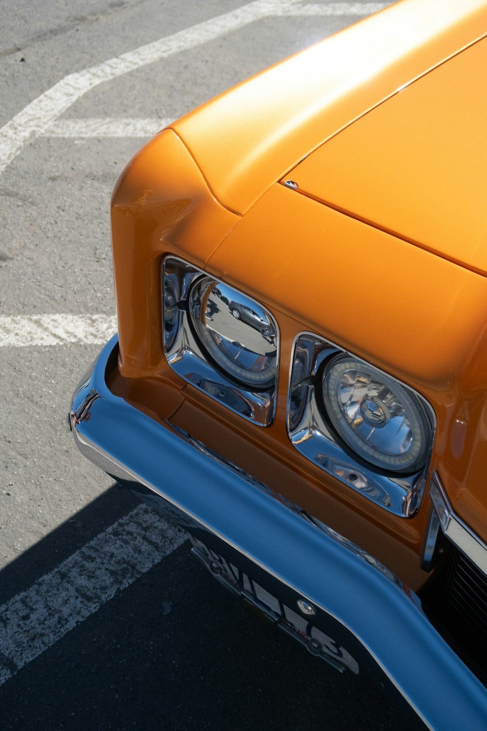 a close up of the front of an orange car