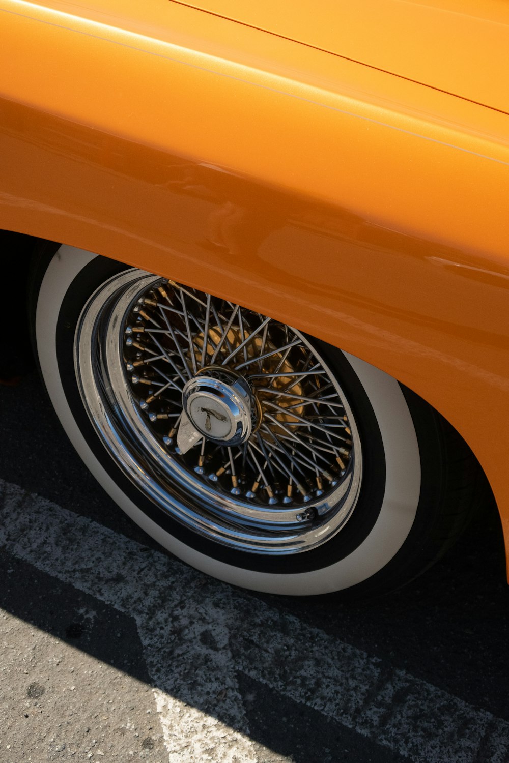 a close up of a wheel on an orange car