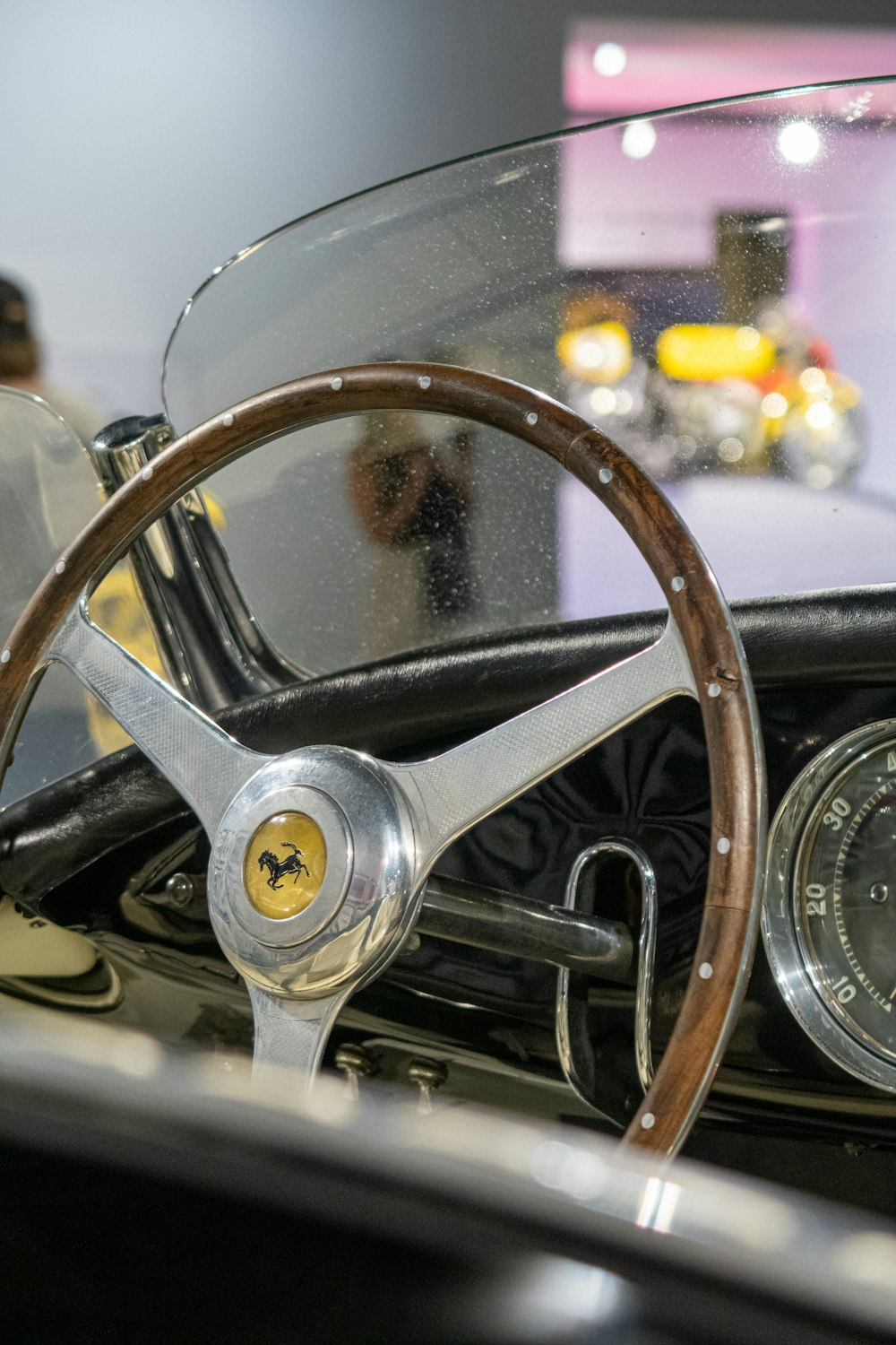 a steering wheel and dashboard of a classic car