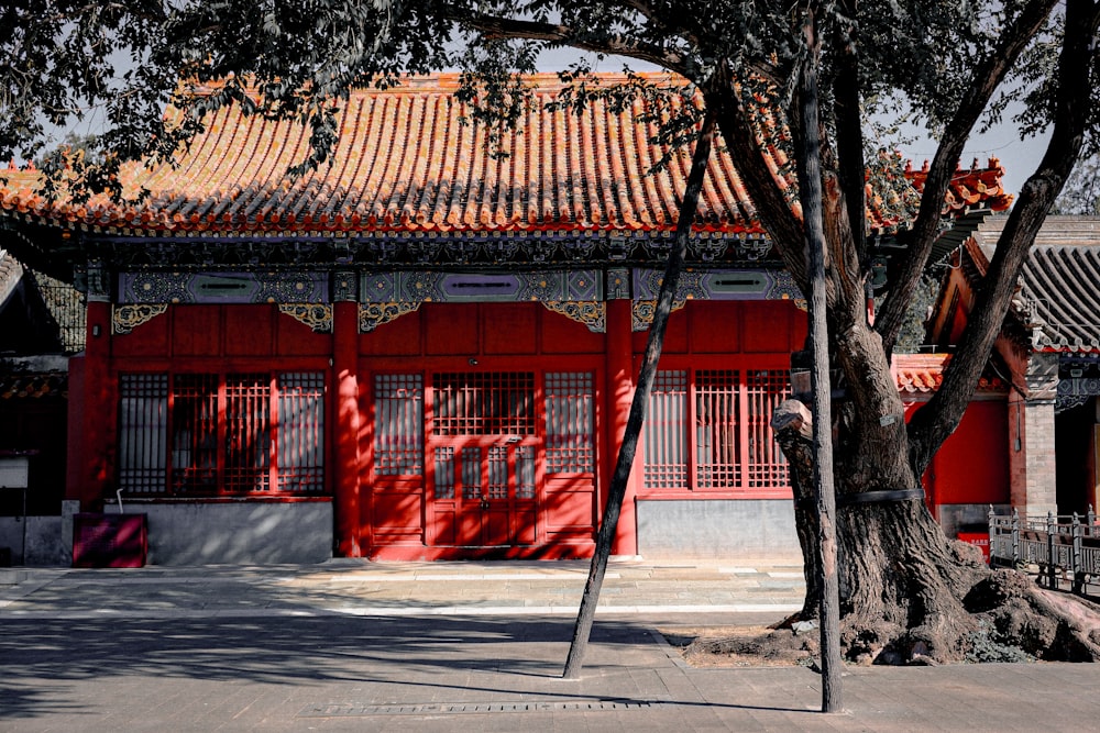 a red building with a tree in front of it