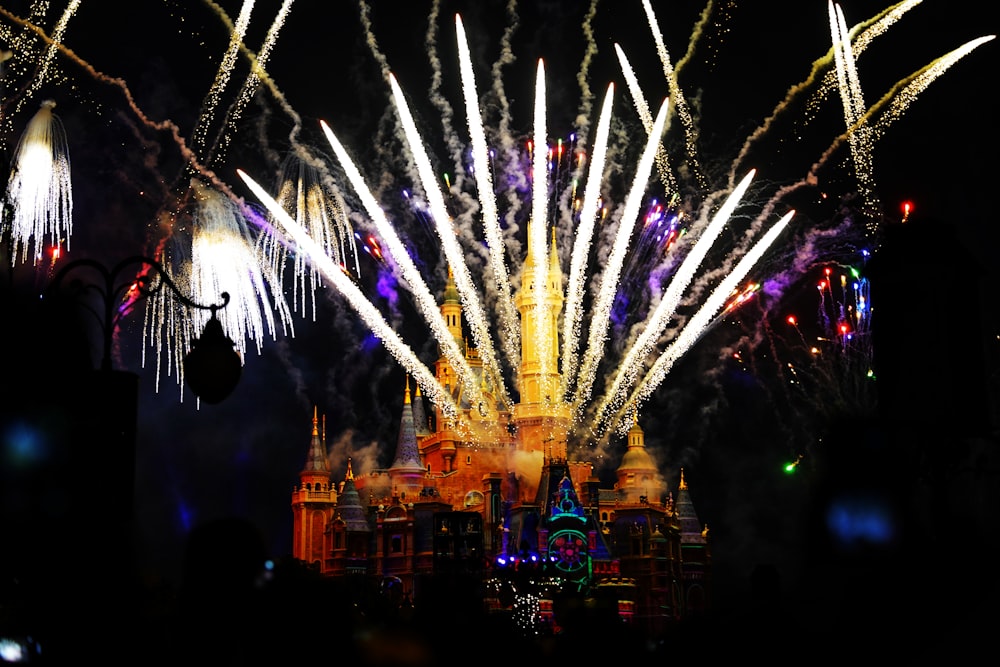 a fireworks display in front of a castle at night