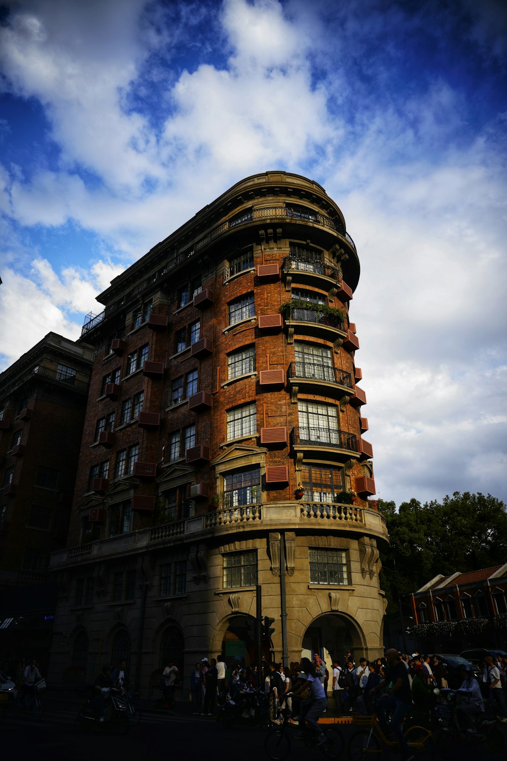 a tall building with lots of windows next to a street