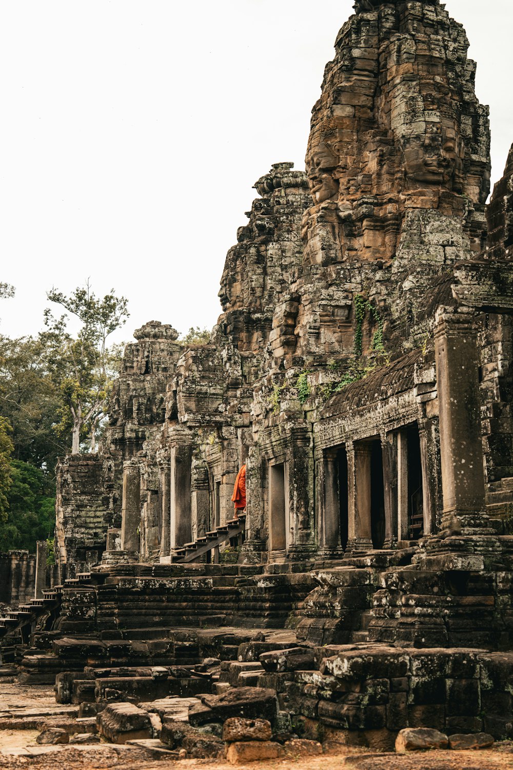 a person standing in front of a stone building