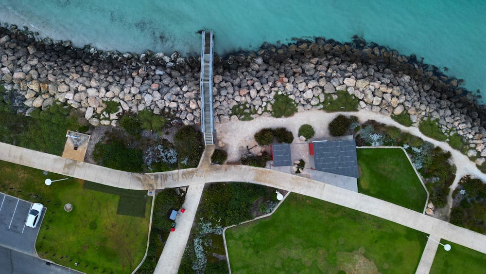 an aerial view of a road and a body of water