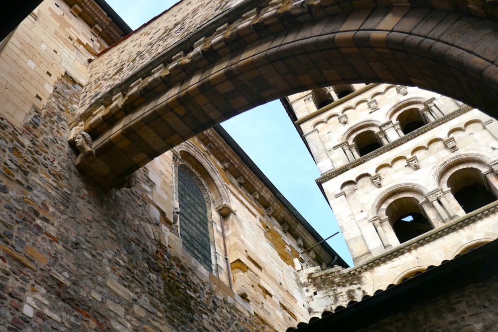 a stone building with a clock tower in the background