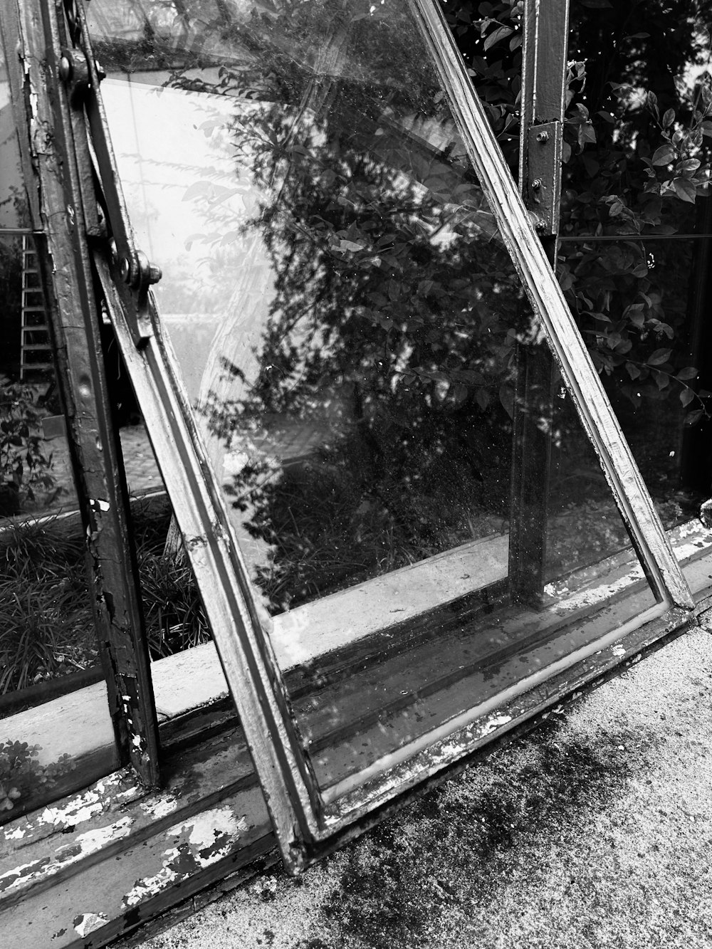 a black and white photo of a broken window