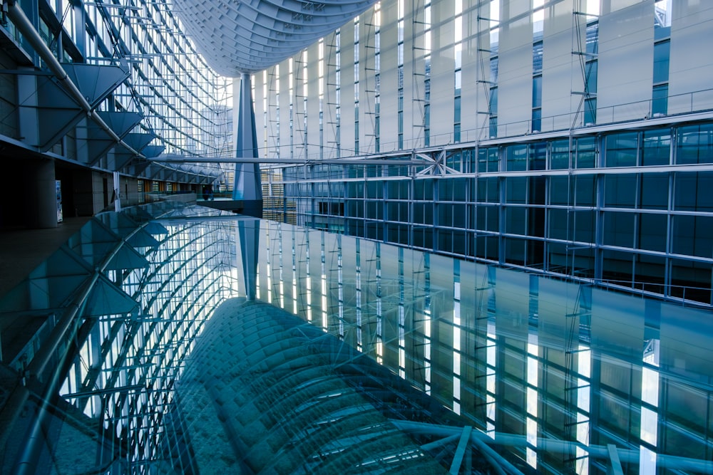 a large building with a large pool of water in front of it