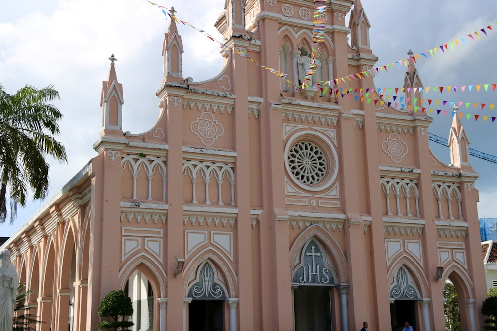 a large pink church with a clock tower