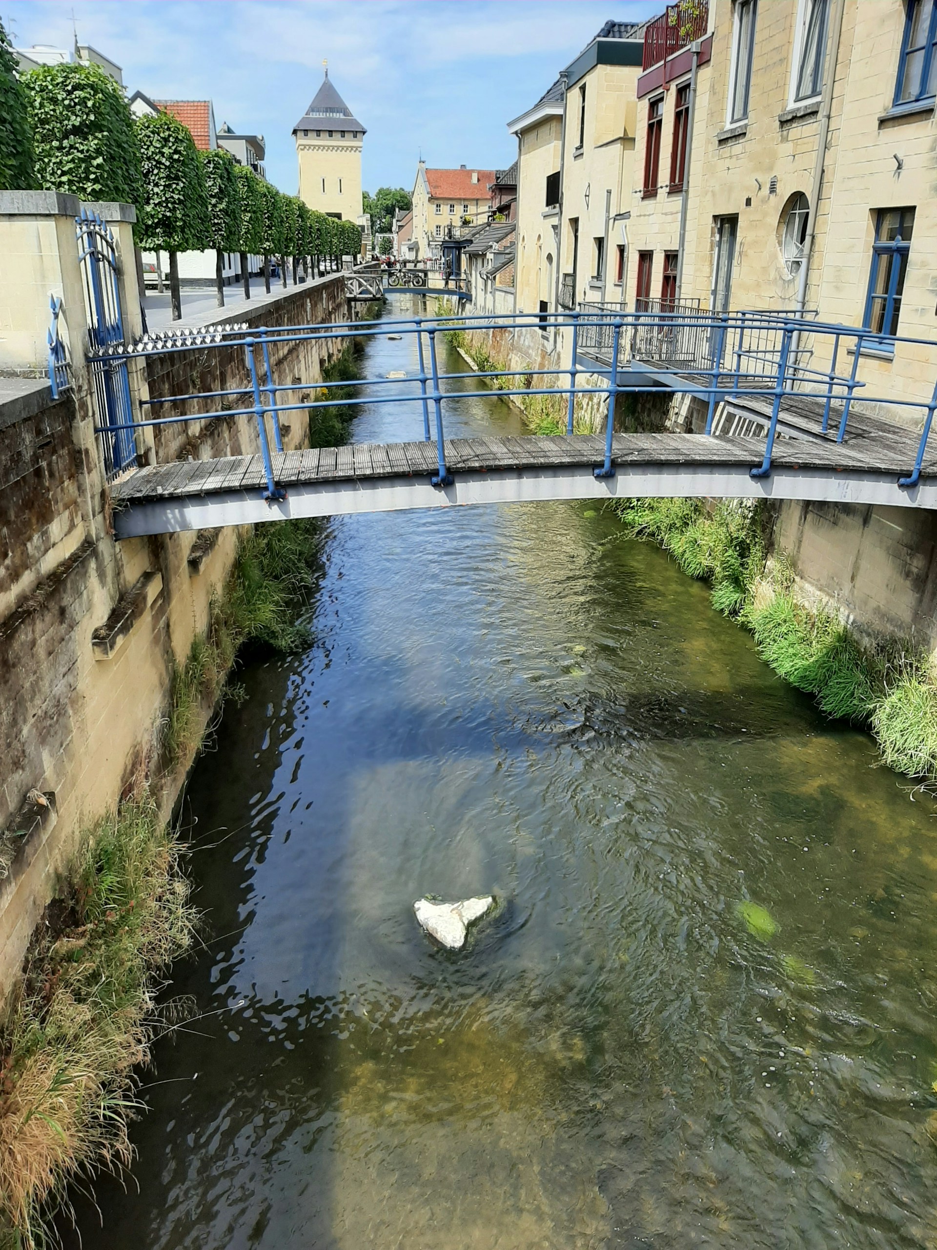 a bridge over a river with a white object floating in it