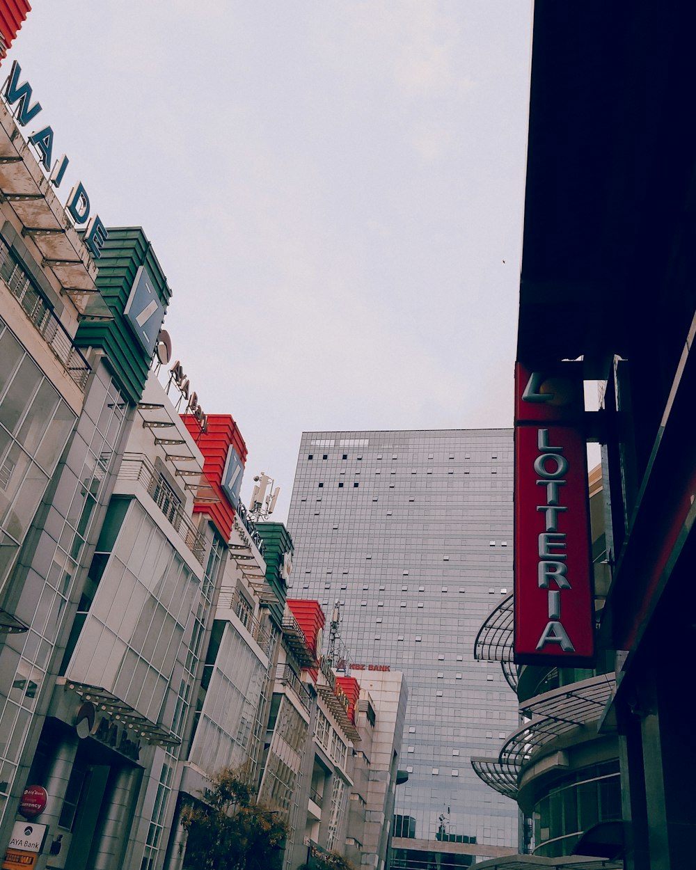 a city street with a tall building in the background