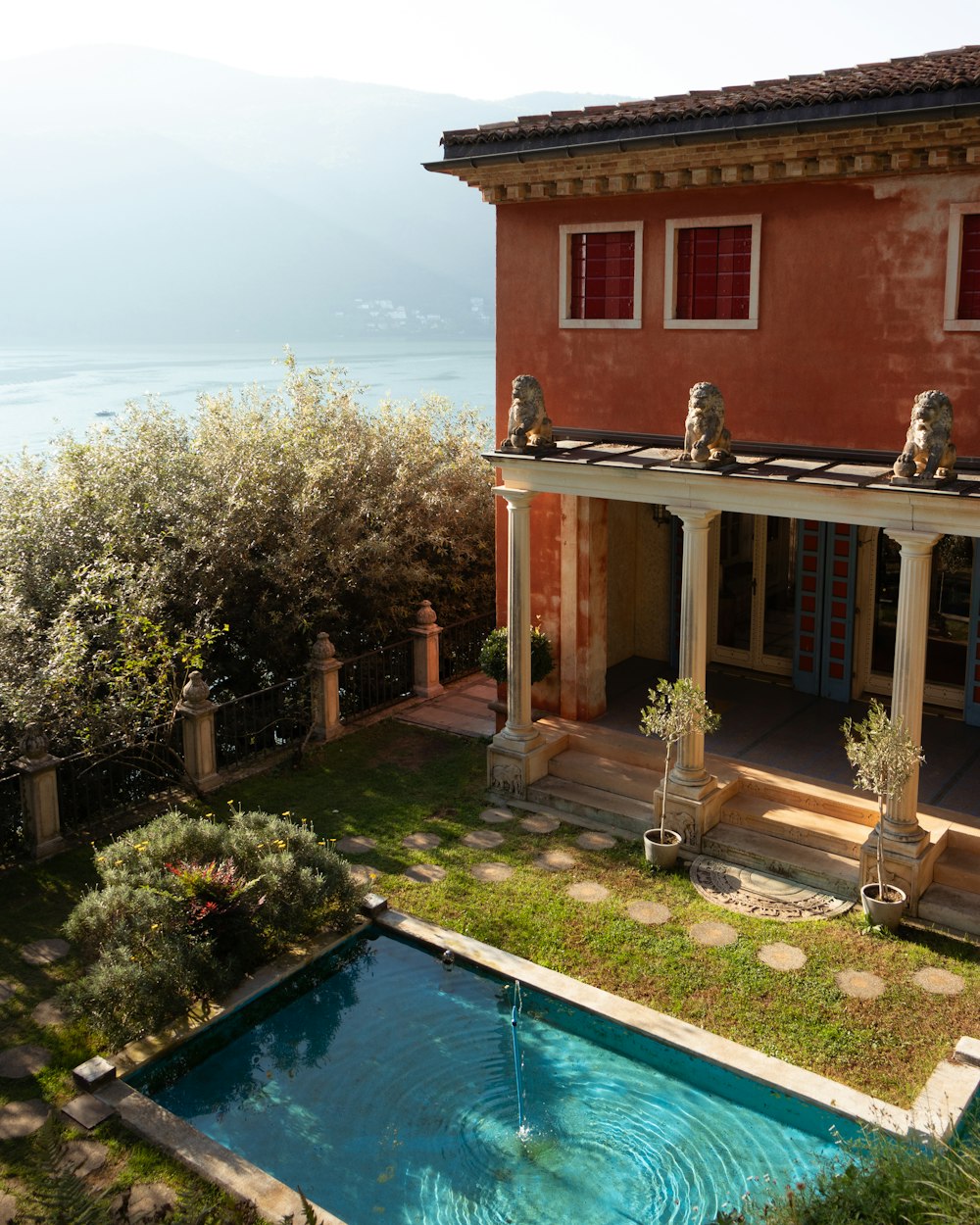 a house with a pool in front of it