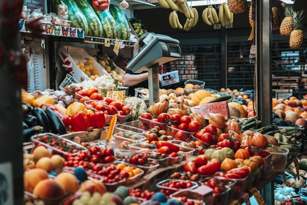 A fruit stand filled with lots of fruits and vegetables