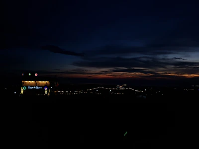 An artistic shot of a sunset during an outdoor event.