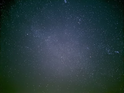 A vast expanse of night sky filled with countless stars, creating a serene and awe-inspiring view of the universe. The tiny specks of light contrast against the dark backdrop, evoking a sense of infinity.
