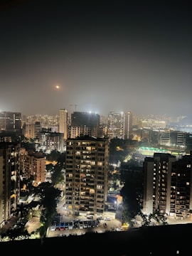 Nighttime cityscape highlighting illuminated infrastructure projects.