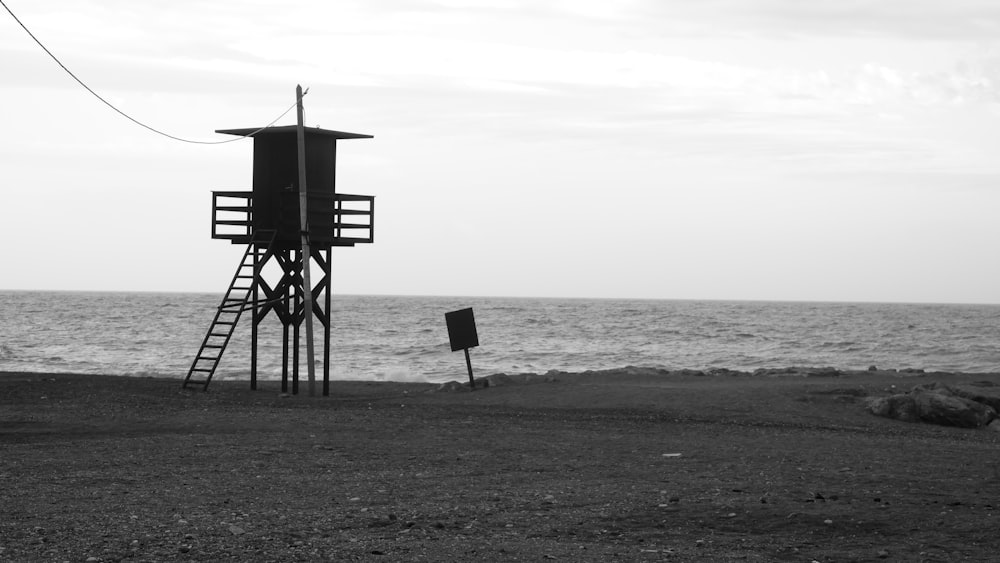a black and white photo of a life guard tower