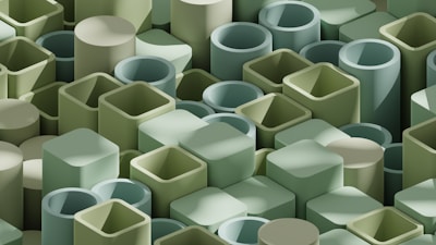 An array of 3D geometric shapes, including cylinders and rectangular prisms, arranged in a dense pattern. The shapes are predominantly in shades of green, creating a harmonious and uniform visual appearance.