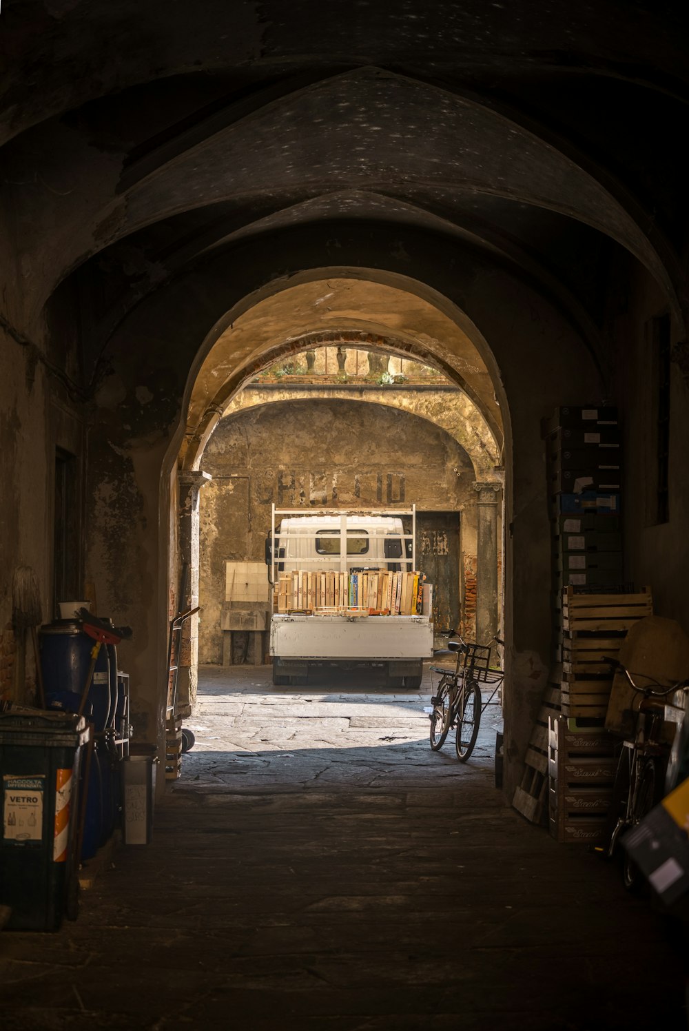 a truck is parked in a tunnel between two buildings