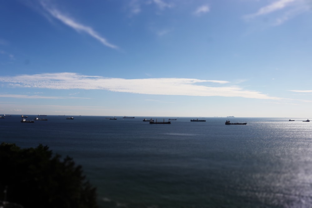 a group of boats floating on top of a large body of water