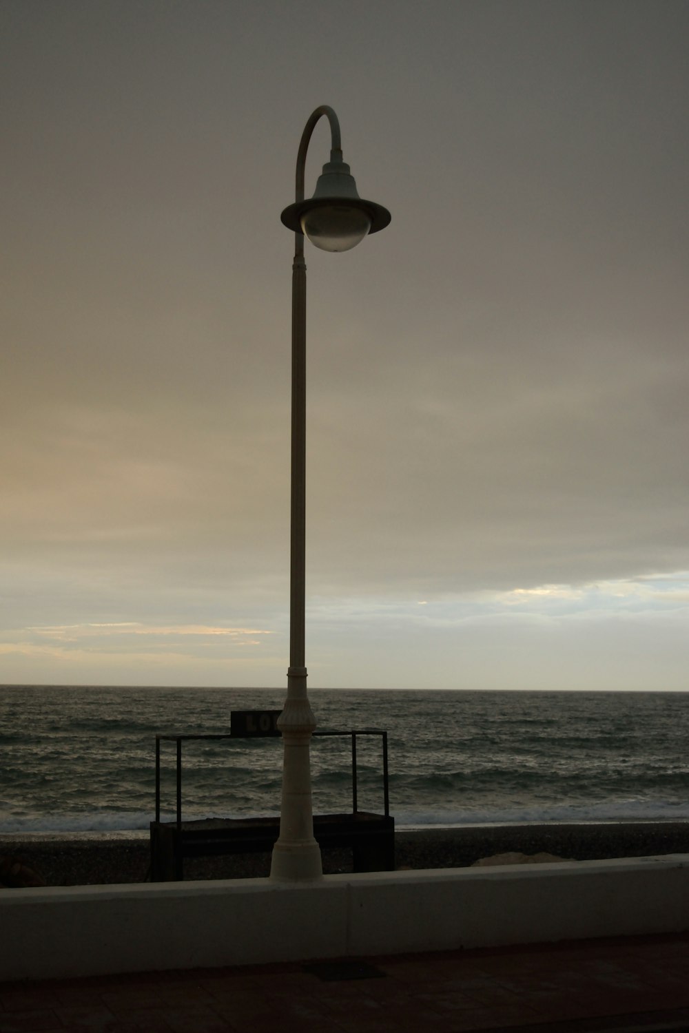 a street light next to a body of water