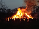 Guests enjoying a bonfire evening with warm lights and mountain backdrop.