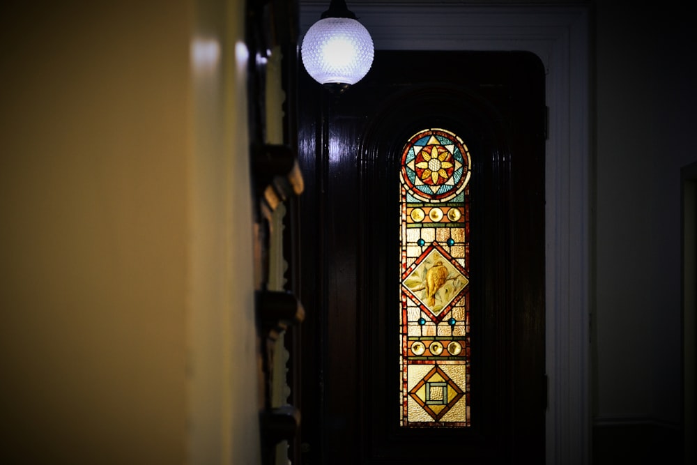 a stained glass window in a dark room