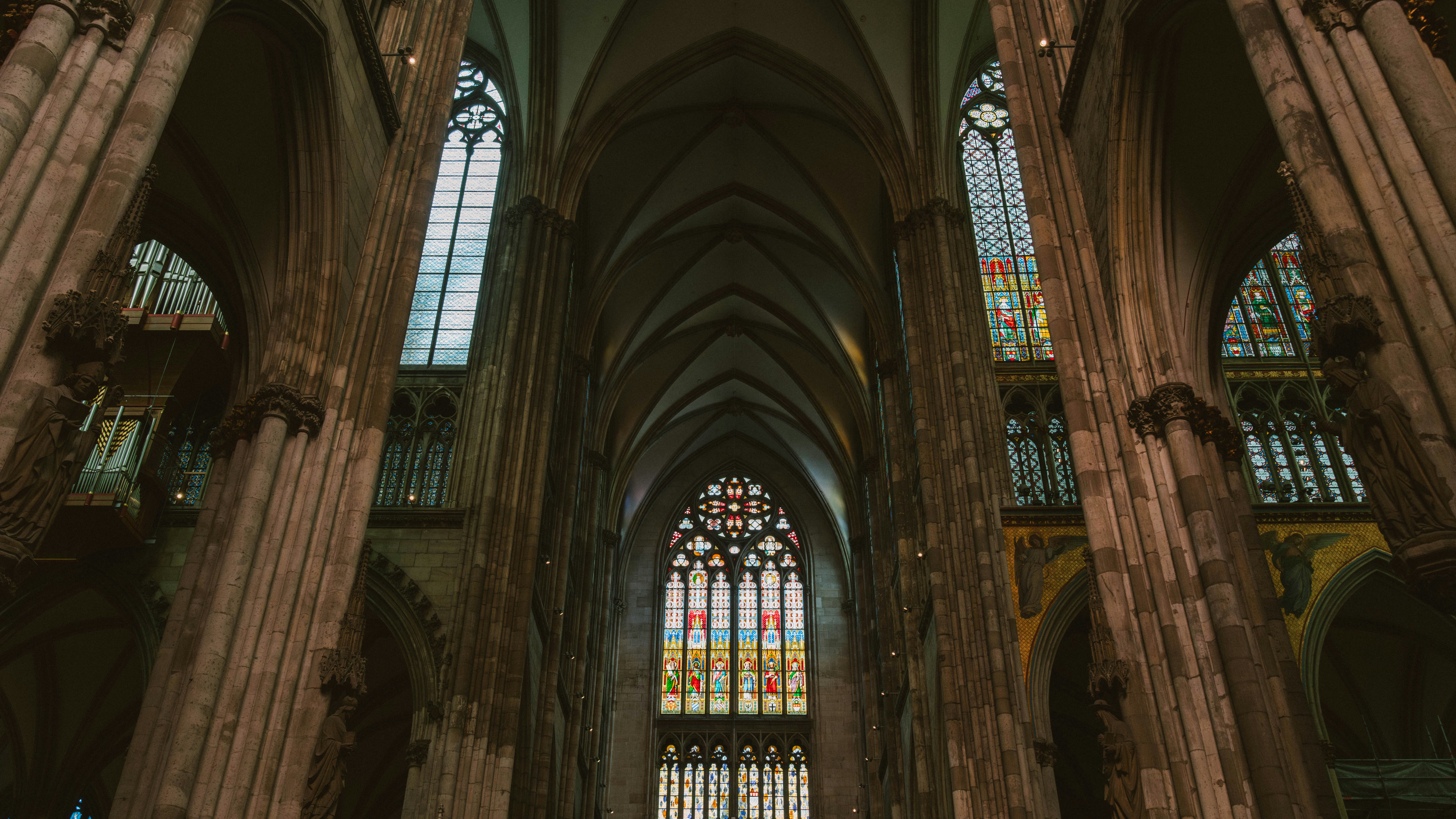 the inside of a cathedral with stained glass windows