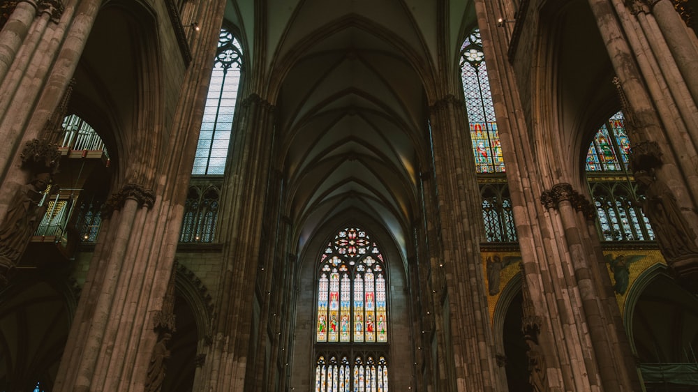 the inside of a cathedral with stained glass windows