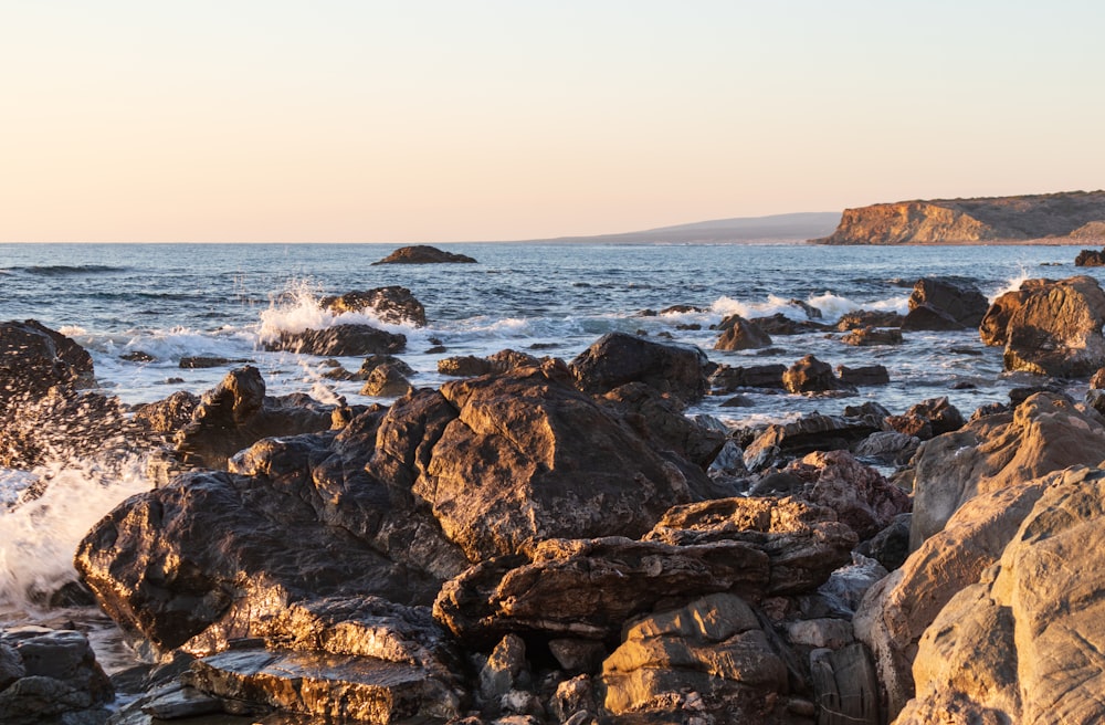 a bunch of rocks that are by the water