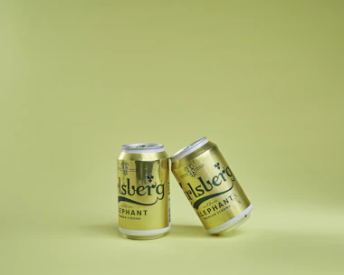 Two branded cans featuring OFC Brands private label design.