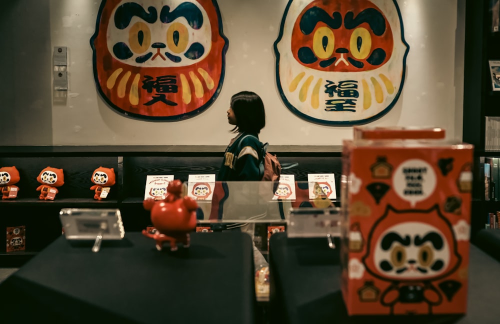 a little girl standing in front of a display case