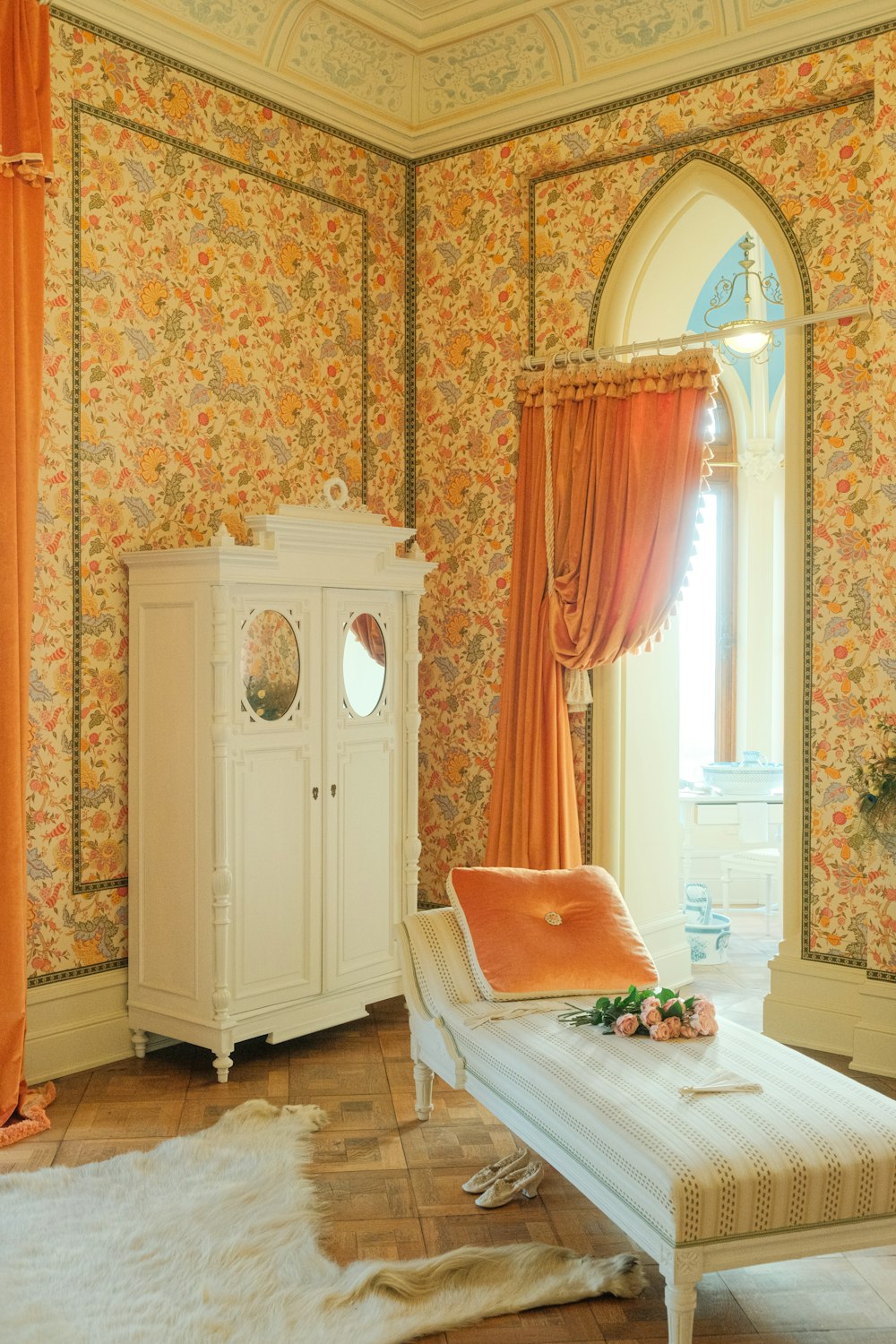 a bedroom with a white bed and a white dresser