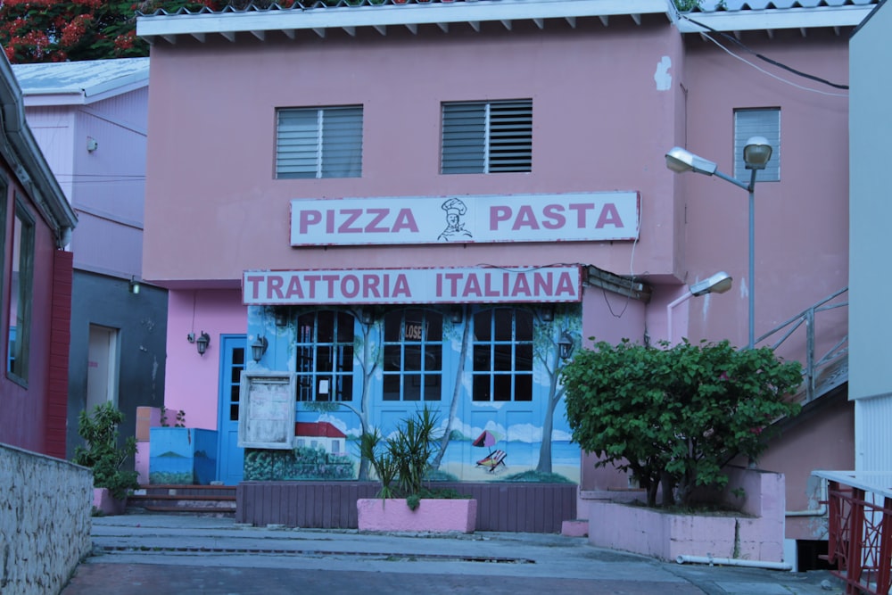 a pink building with a mural on the side of it